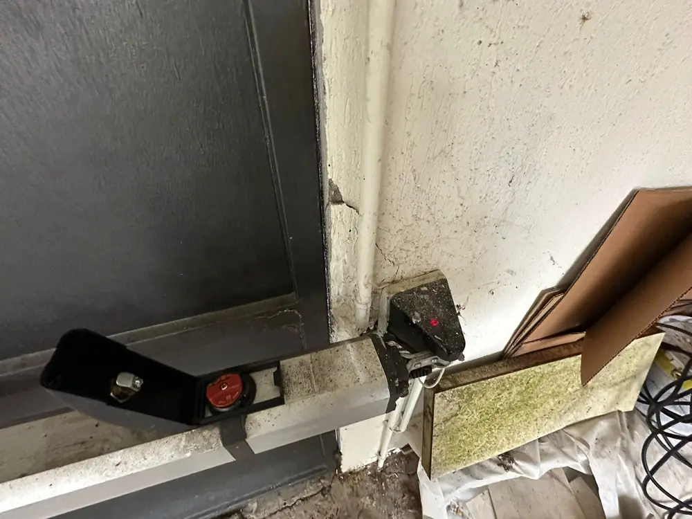 Bras de motorisation d’une porte de garage, fixation à contrôler