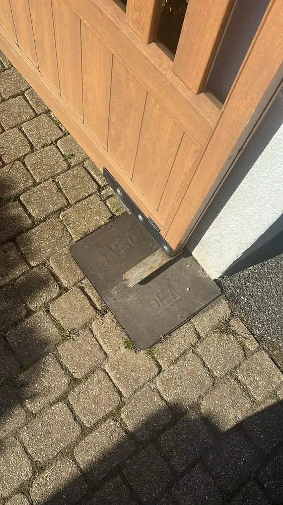 Pied d’un vantail en bois sur sa butée au sol