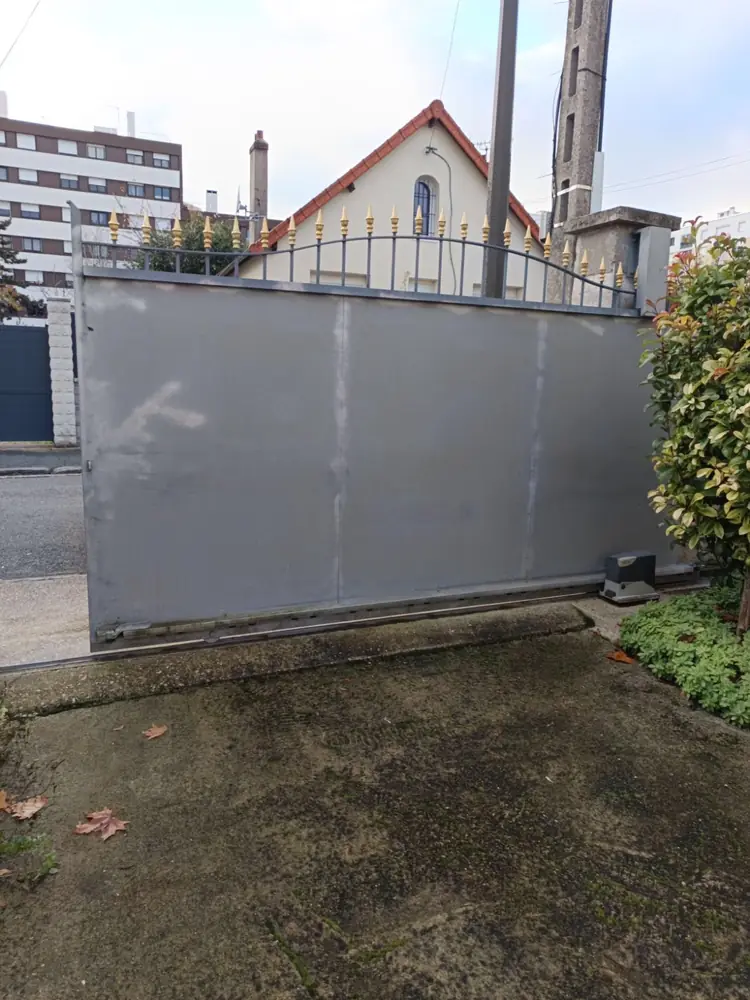 Portail coulissant plein en aluminium gris, refoulement le long du mur
