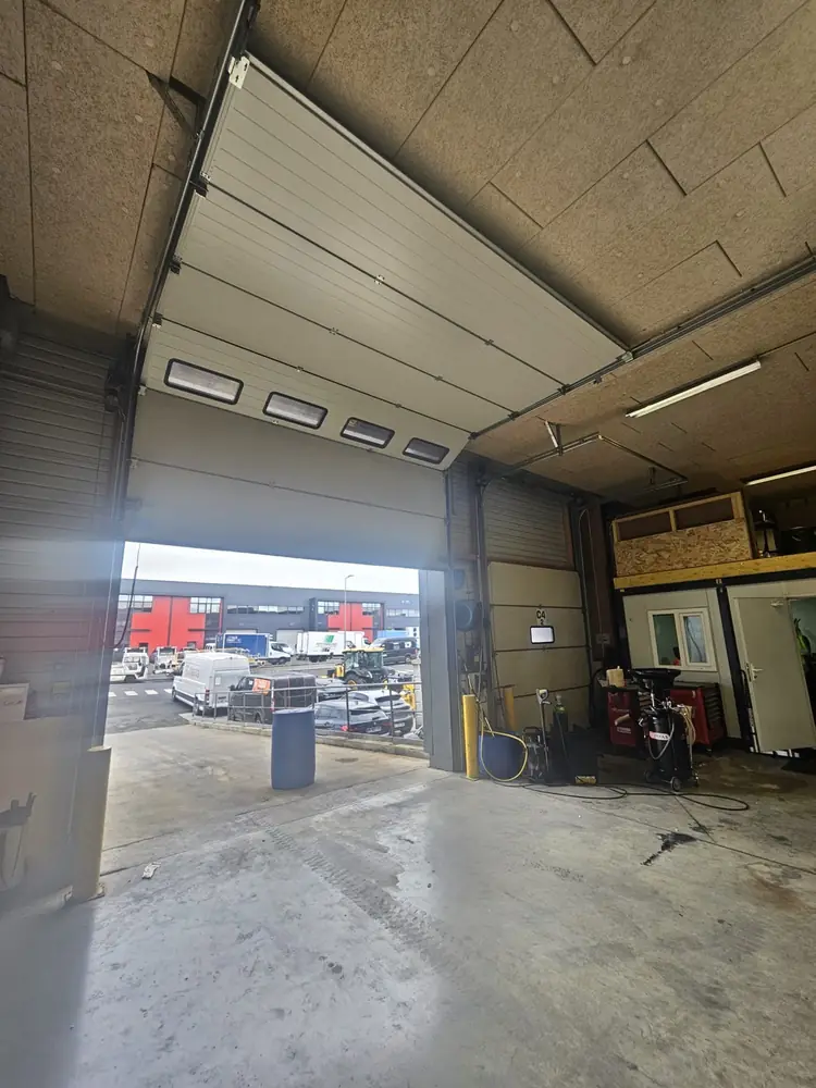 Porte sectionnelle industrielle ouverte sur un atelier